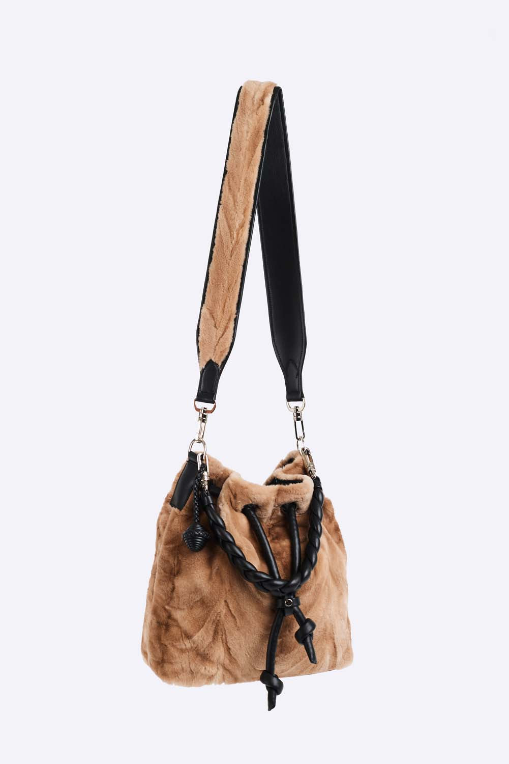 Upcycled natural mink cross body purse. Inside zip patch pocket, polyester lining and leather trim. Cross body fur strap and hand braided high shoulder strap. Handmade leather accessories as well as cut, dyed and stitched by hand. Hand made in Montreal.