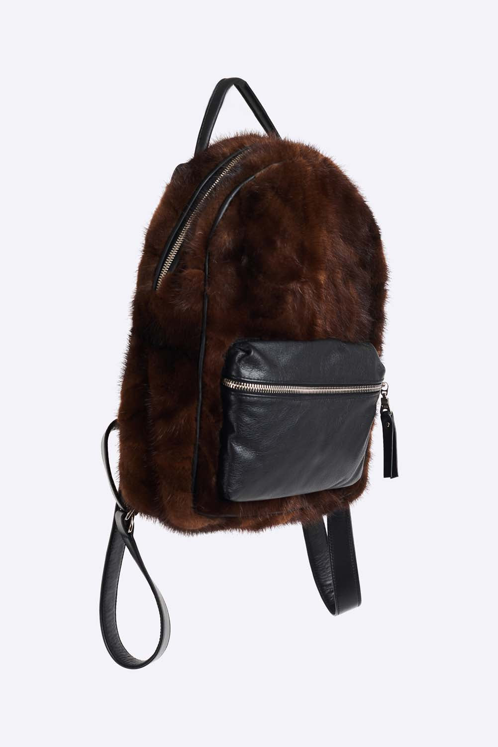 Upcycled mink fur mini backpack. Front leather zip pocket and adjustable backpack straps. Single leather handle and polyester lining. Leather trim and hand polished zipper (Excella). Hand made in Montreal. 